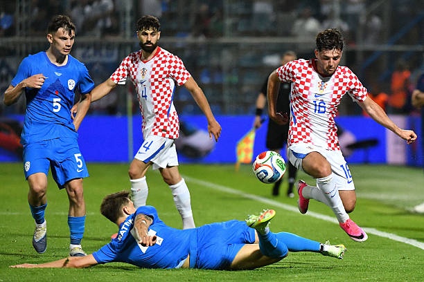 Marcel Ratnik of Slovenia and Martin Baturina of Croatia compete for the ball during the international friendly match between Croatia and Slovenia at Stadium Varteks on June 7, 2026 in Varazdin, Croatia.